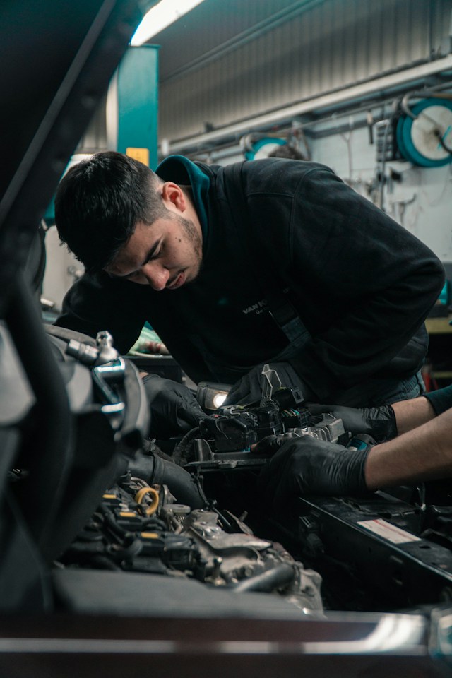 man repair a car